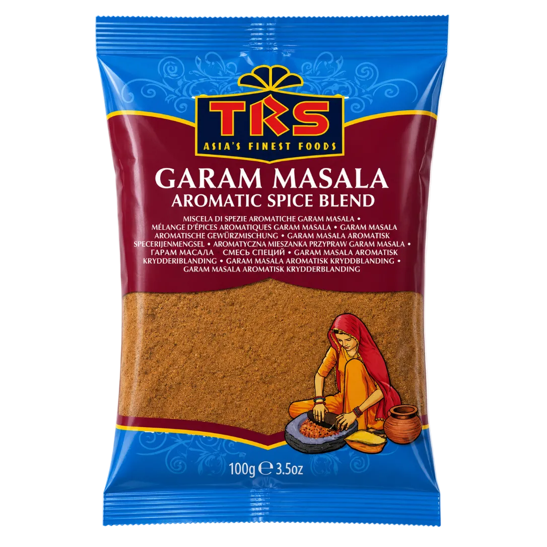 A 100g package of TKS Garam Masala aromatic spice blend. The packaging features a blue top and bottom border, a dark red central band with the brand name 'TRS' in gold and red, and a clear window showing the brown spice blend inside.