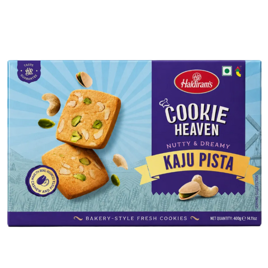 A 400g box of Haldiram's Cookie Heaven Kaju Pista cookies, featuring a light blue and dark purple design with images of cookies topped with cashews and pistachios.