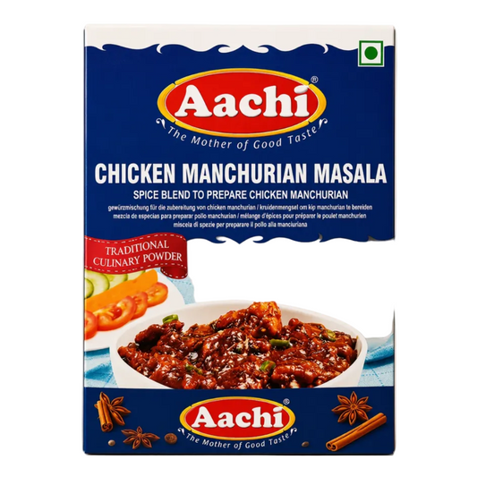 A rectangular box of Aachi Chicken Manchurian Masala spice blend, shown upright against a plain warm beige background. The packaging is predominantly dark blue with a large red oval Aachi logo, white product name text, and food photography of prepared chicken on the front.