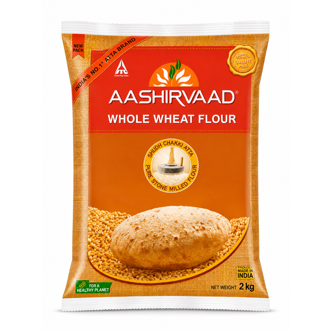 A 2 kg bag of Aashirvaad Whole Wheat Flour on a plain white background. The packaging features a bright orange and red design with a depiction of a whole wheat bread loaf and loose wheat grains.