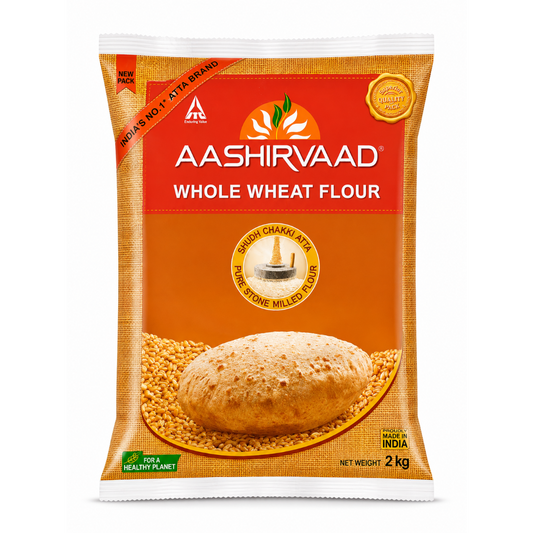 A 2 kg bag of Aashirvaad Whole Wheat Flour on a plain white background. The packaging features a bright orange and red design with a depiction of a whole wheat bread loaf and loose wheat grains.