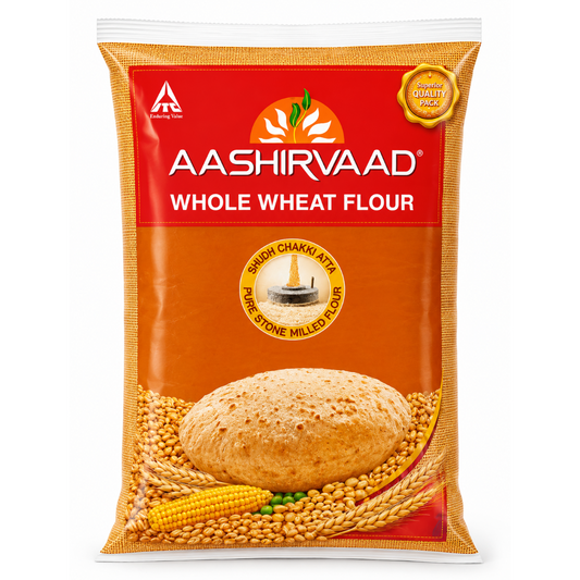 Aashirvaad Whole Wheat Flour in a 1 kg bag. The packaging features a bright red top section with the brand name in white, a golden-brown lower section, and an illustration of a whole wheat loaf surrounded by wheat, soybeans, and corn.