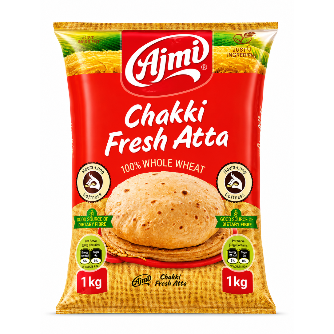 A 1 kg bag of Ajmi Chakki Fresh Atta whole wheat flour, featuring a bright red and golden-yellow packaging design with a photo of a cooked flatbread in the center.