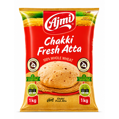 A 1 kg bag of Ajmi Chakki Fresh Atta whole wheat flour, featuring a bright red and golden-yellow packaging design with a photo of a cooked flatbread in the center.