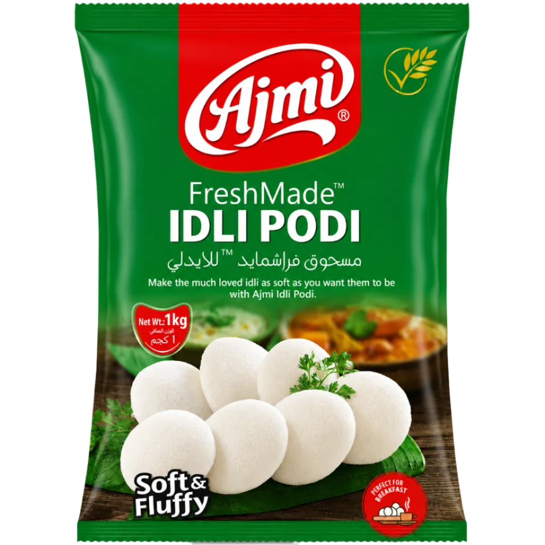 Ajmi FreshMade Idli Podi packaging, featuring a green and red bag with white idli balls pictured on the front, labeled 'Soft & Fluffy'.