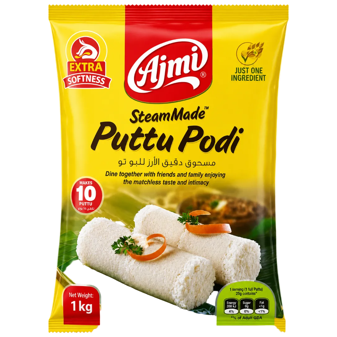 A 1 kg package of Ajmi SteamMade Puttu Podi, featuring a bright yellow bag with red and green branding, showing cooked puttu podi rolls on the front.