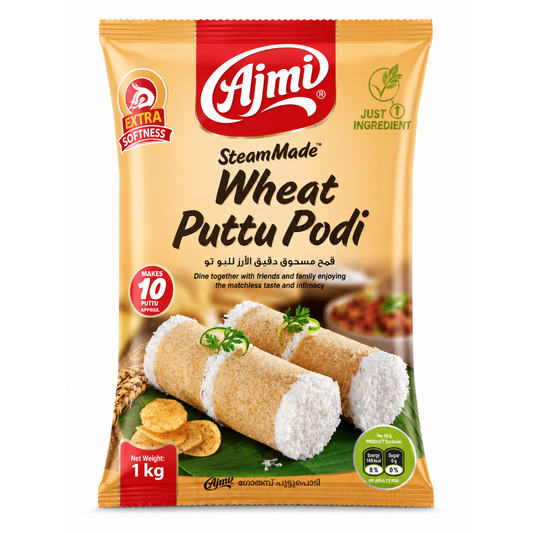 A 1 kg bag of Ajmi SteamMade Wheat Puttu Podi, featuring a golden-yellow packaging design with red and green accents, showing the prepared puttu podi rolls on the front.