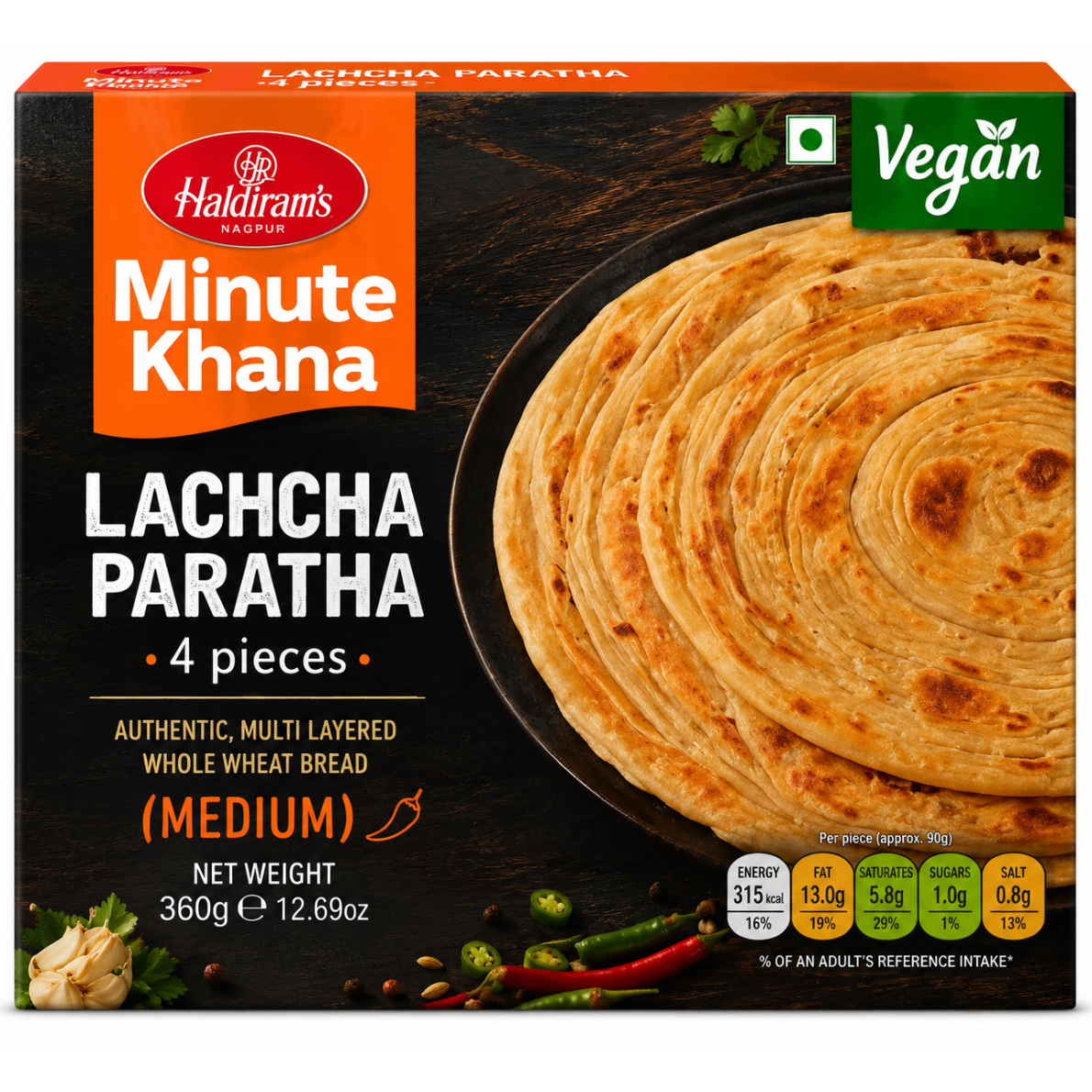 Haldiram's Minute Khana Lachcha Paratha (Medium) packaging box, featuring a stack of golden-brown layered flatbreads on a dark wood-textured background, with brand logo, vegan badge, and nutritional information.