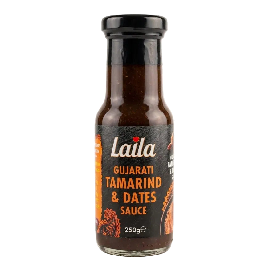 A 250g glass bottle of Laila Gujarati Tamarind & Dates Sauce, featuring a black label with white and orange text and illustrations, topped with a black cap, set against a plain white background.