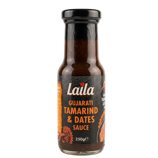 A 250g glass bottle of Laila Gujarati Tamarind & Dates Sauce, featuring a black label with white and orange text and illustrations, topped with a black cap, set against a plain white background.