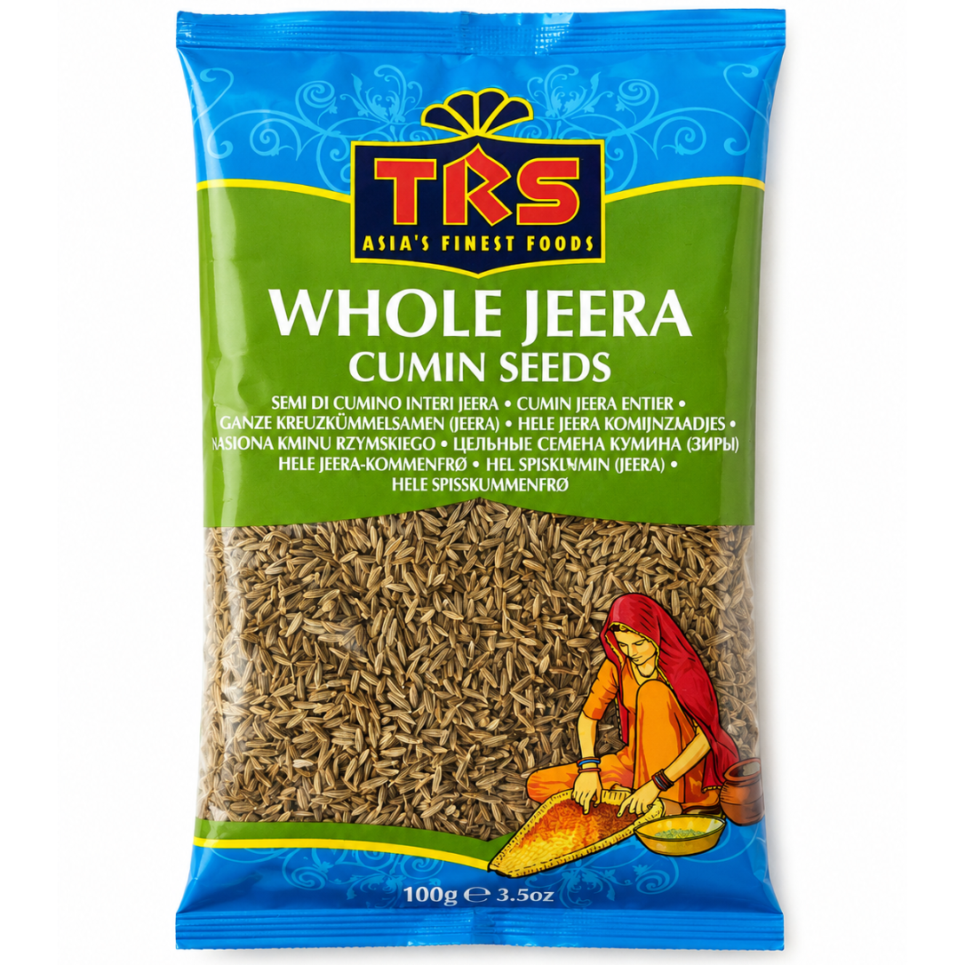 A 100g bag of TKS Whole Jeera Cumin Seeds on a plain white background. The packaging features a blue top section with the TKS logo, a green middle section with product text, and a clear window showing the brown cumin seeds inside.
