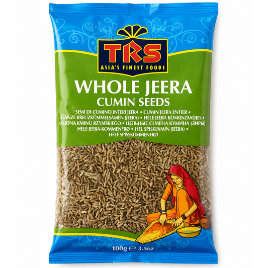 A 100g bag of TKS Whole Jeera Cumin Seeds on a plain white background. The packaging features a blue top section with the TKS logo, a green middle section with product text, and a clear window showing the brown cumin seeds inside.