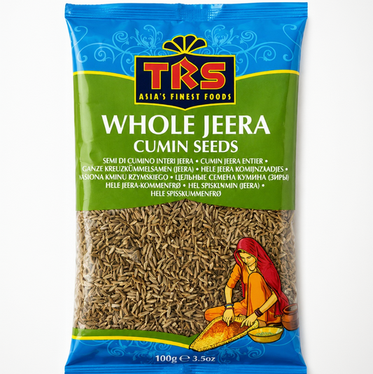 A 100g bag of TKS Whole Jeera Cumin Seeds on a plain white background. The packaging features a blue top section with the TKS logo, a green middle section with product text, and a clear window showing the brown cumin seeds inside.